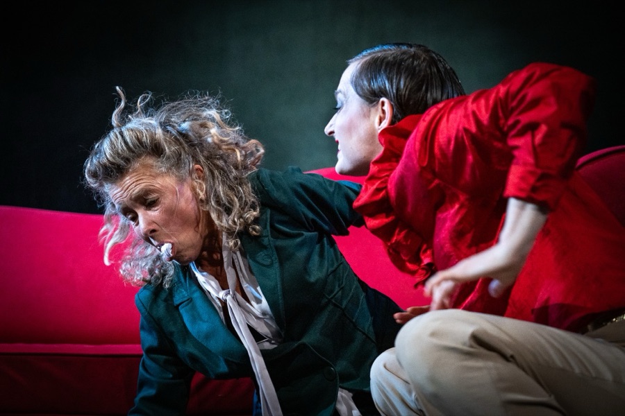 Mamy and Gaby struggle on the red sofa.